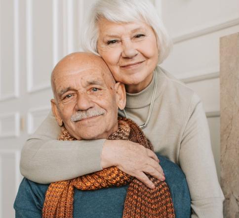 A mesothelioma patient is hugged by his wife